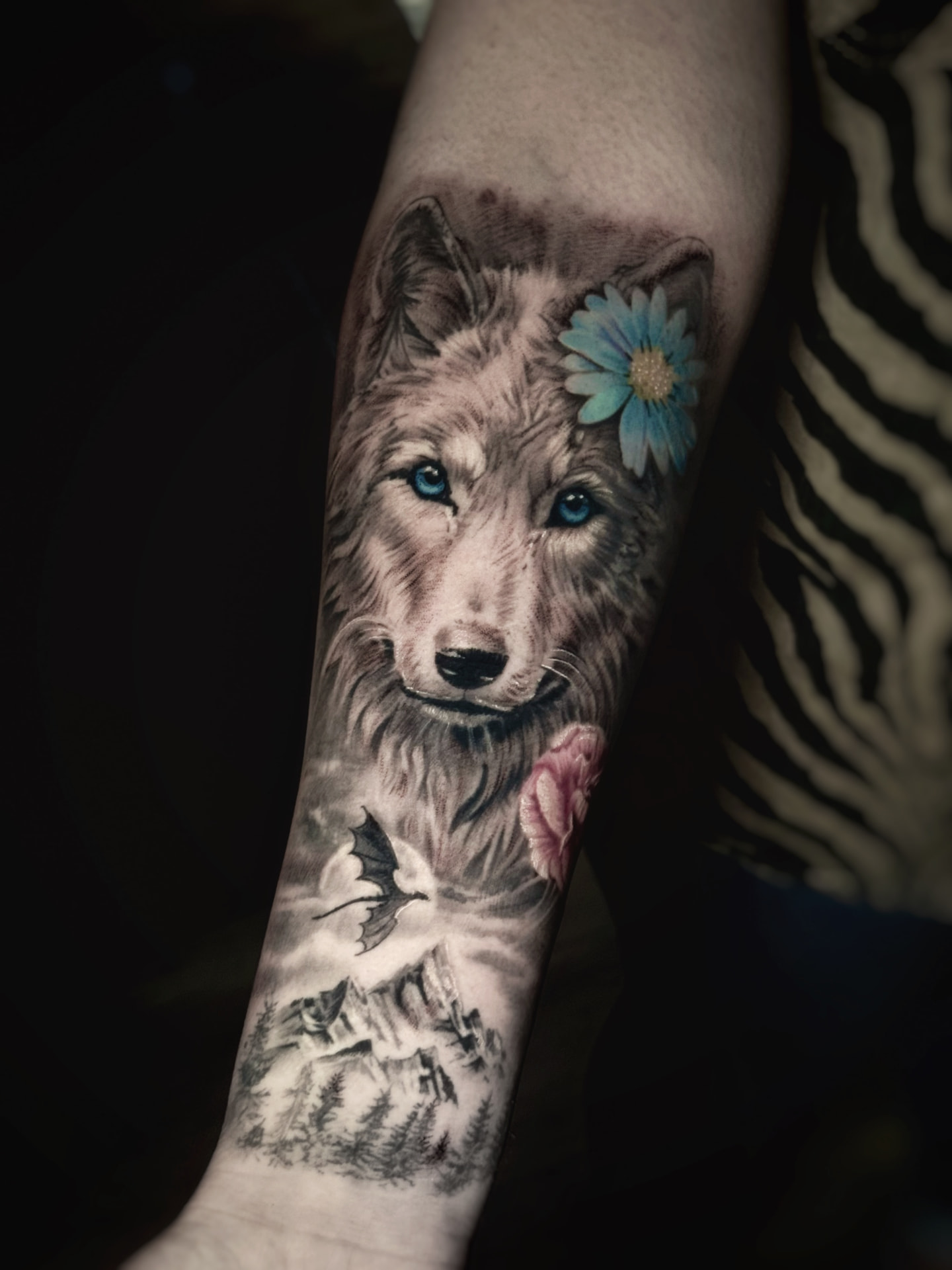 Wolf forearm piece with blue eyes, flowers, dragon and mountains
